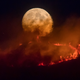 The full moon rises over the Saddleworth Moor fire.